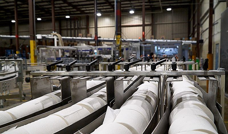 Detail image of bath tissue rolls being manufactured in facility